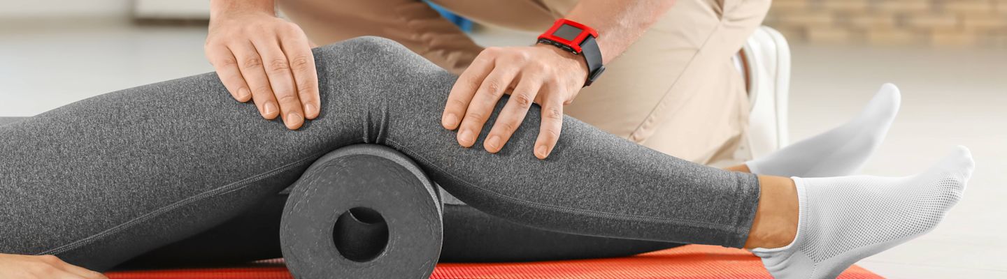 Physiotherapist working with young female patient in clinic
