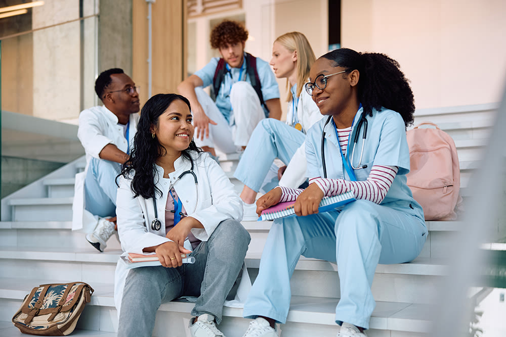 Medical students sitting on stairs