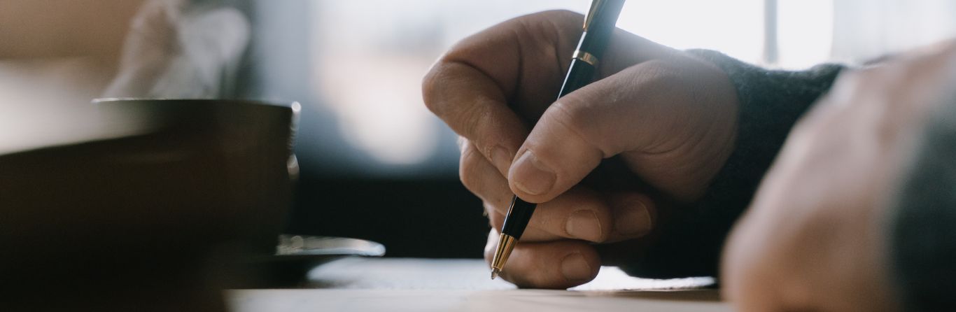 A student writing with a pen