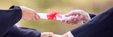 hands passing a diploma - How to Choose Between a Certificate, Diploma, and Degree in Canada - CA