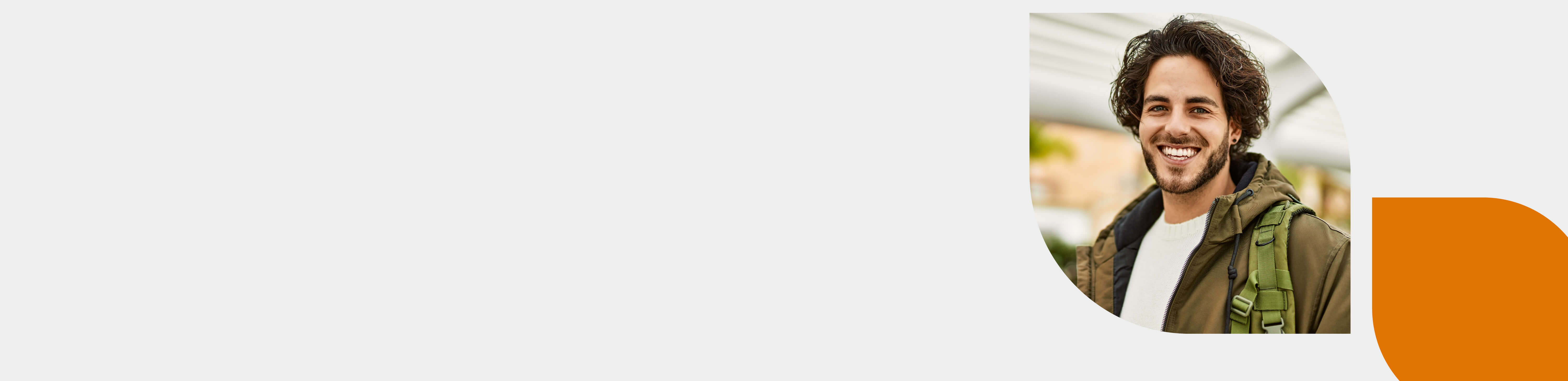 An executive employee is standing infront of office buildings