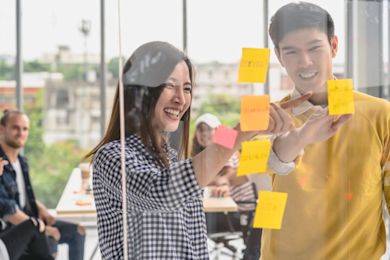 Two students are making note of the things to consider when choosing an offer.