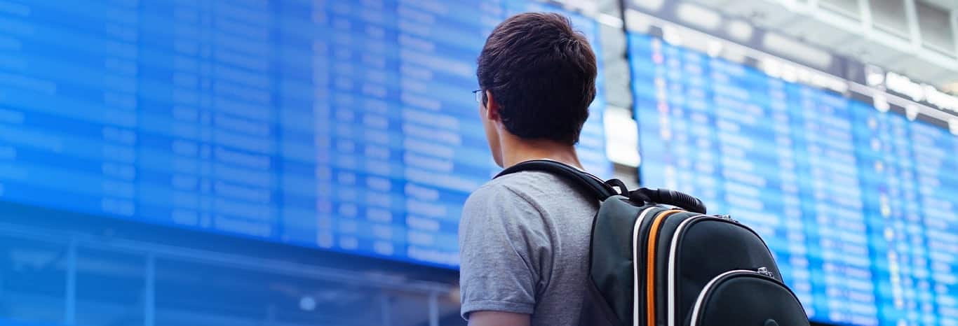 The picture of a person from behind with a bag 