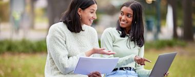 A student writing a research proposal in his laptop