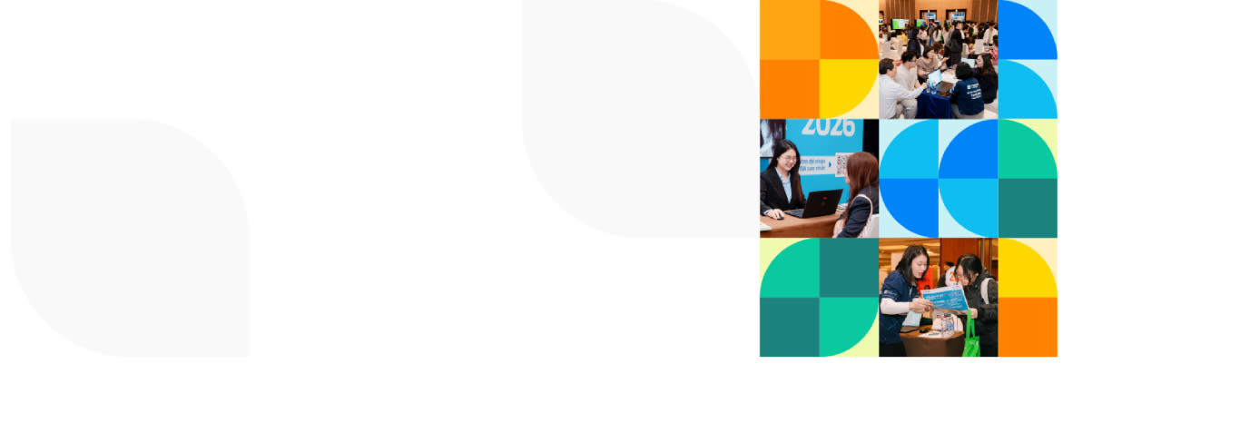 A vibrant event space filled with attendees, booths showcasing technology, and engaging displays under warm lighting