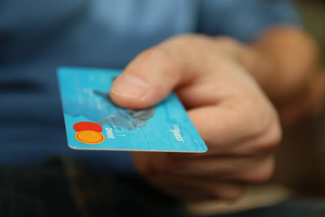 A picture of a hand holding a credit card