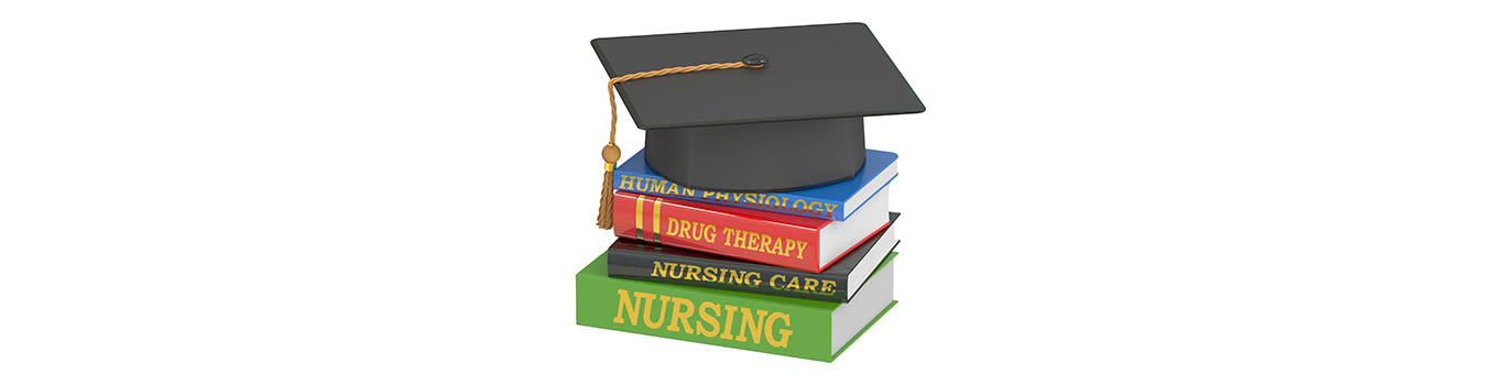Nursing education concept, graduation cap atop a pile of text books.