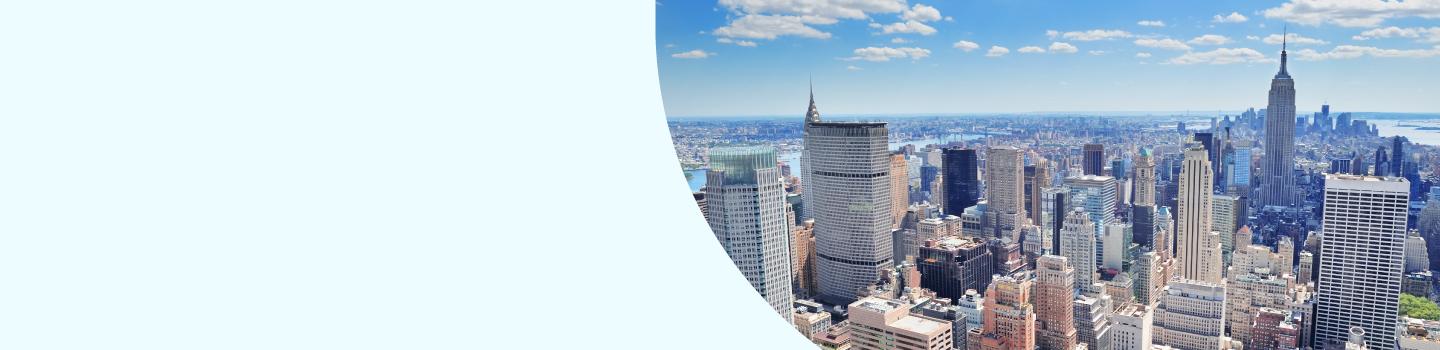 A city skyline with numerous skyscrapers under a clear blue sky. The view includes prominent buildings and a river in the background. The left side of the image features a large blank light blue area.