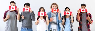 BANNER - IDP - Life in Canada - Canada - A group of people with Canadian flags across their mouths