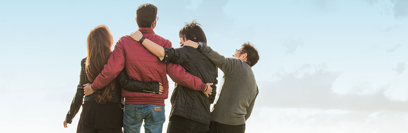 four friends embracing