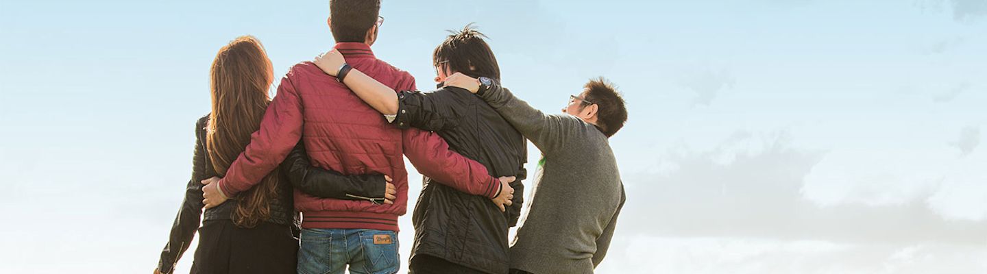 four friends embracing