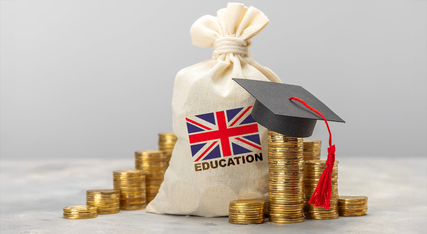 Education in the UK.. Stack of coins and graduate hat