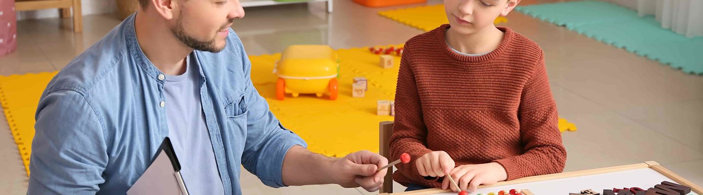 Child welfare specialist interacting with a male child.