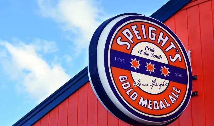 A sign board with the logo of Speights's gold medal ale that reads pride of the south and has three stars in the middle