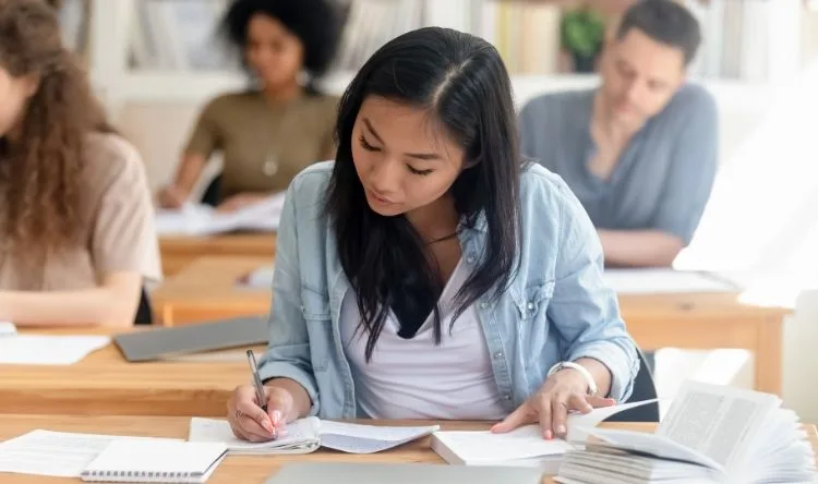 A female student writing a scholarship exam