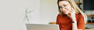 A female international student working on a laptop