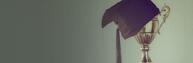 An image of trophy and graduation cap.