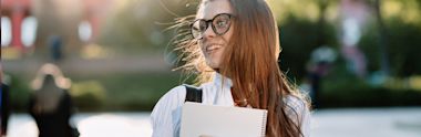 A female student walking with her books