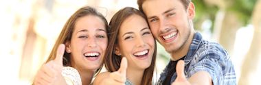 Group of friends giving thumbs-up to the camera