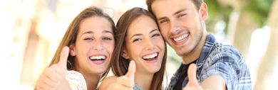 Group of friends giving thumbs-up to the camera 