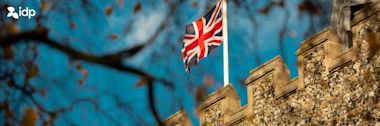 UK flag waving in the air on top of a building