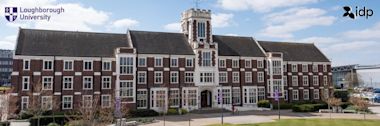 A large, historic brick building at Loughborough University with white-trimmed windows and a central clock tower, viewed under a sunny sky with a few clouds. Logos for Loughborough University and IDP appear in the corners.