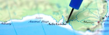 Blue pushpin marking Adelaide on a map of South Australia, showing coastline and surrounding regions