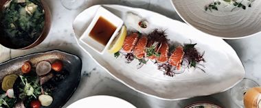 Different Japanese food plated on a table, including sushi.