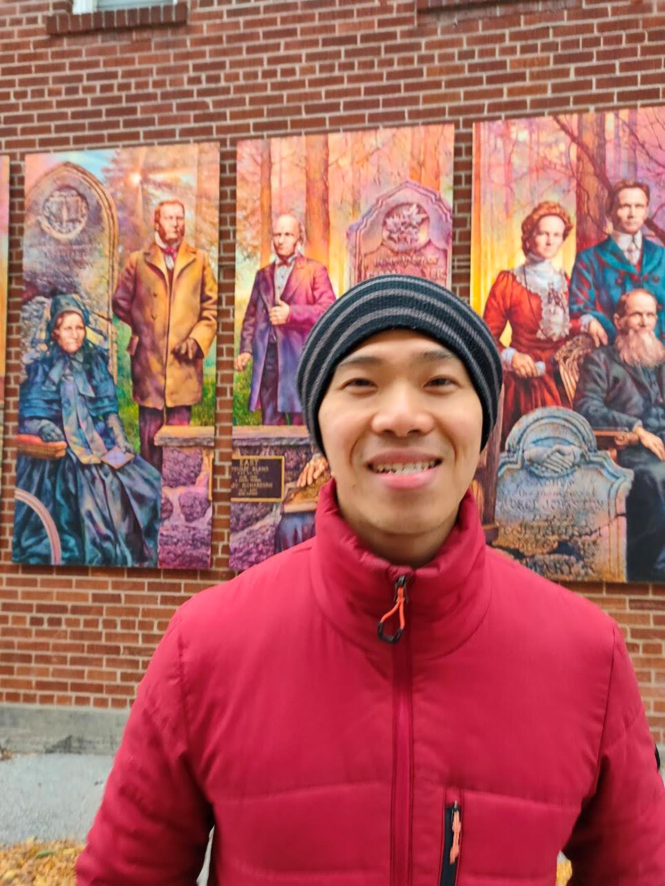 Shih-Chieh Cheng, International student against a wall with images on it