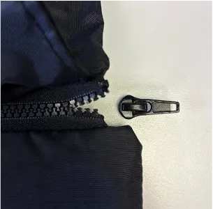 Product recall notice - Image showing the zip pull on affected products detached from the zip
