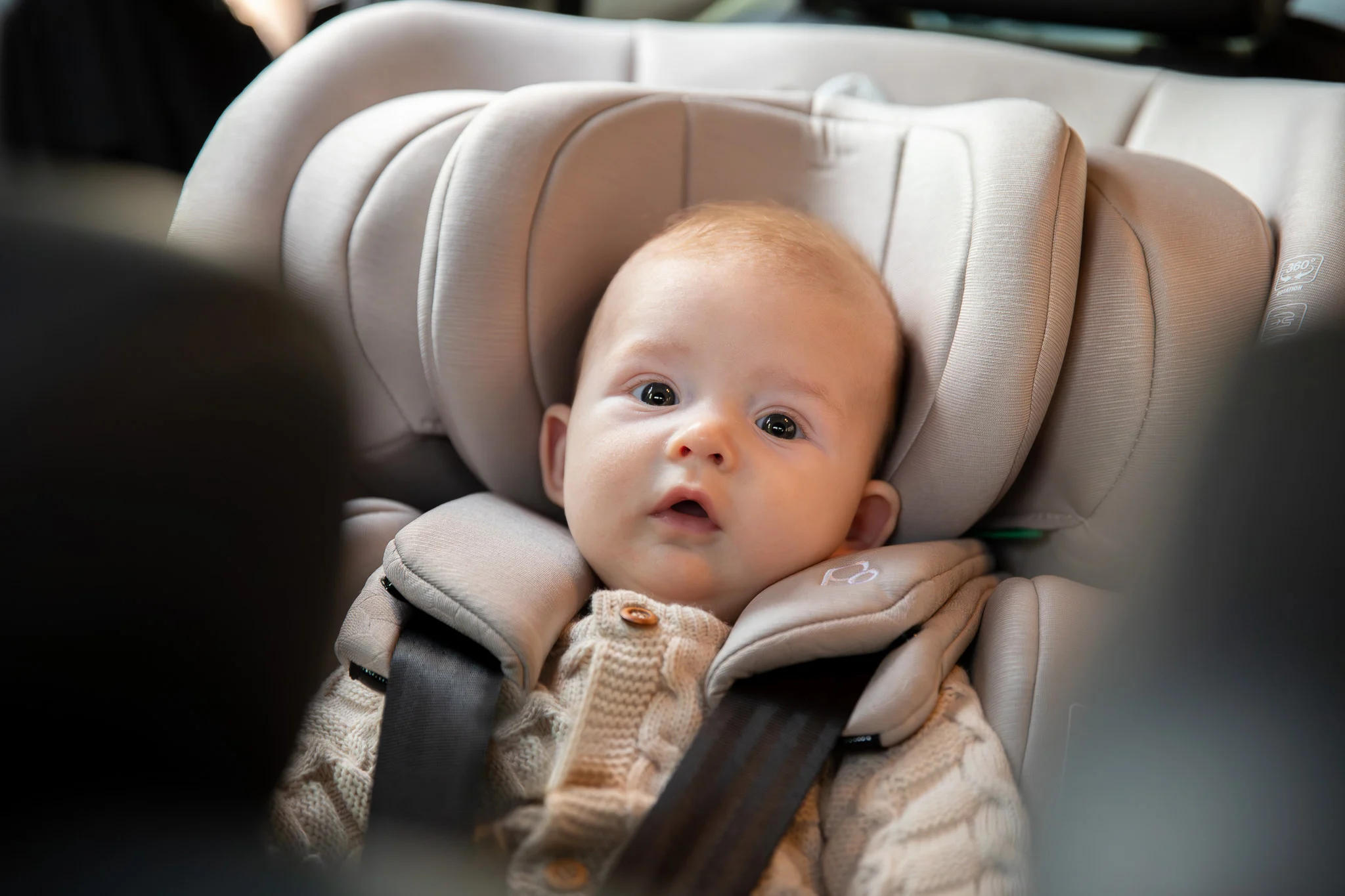 Child in Puggle car seat