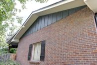 Home side with brick and siding