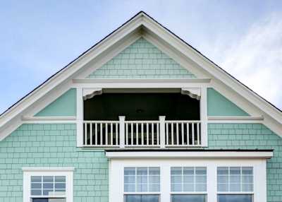 beautiful teal and white house that was painted by Colorado Siding Repair