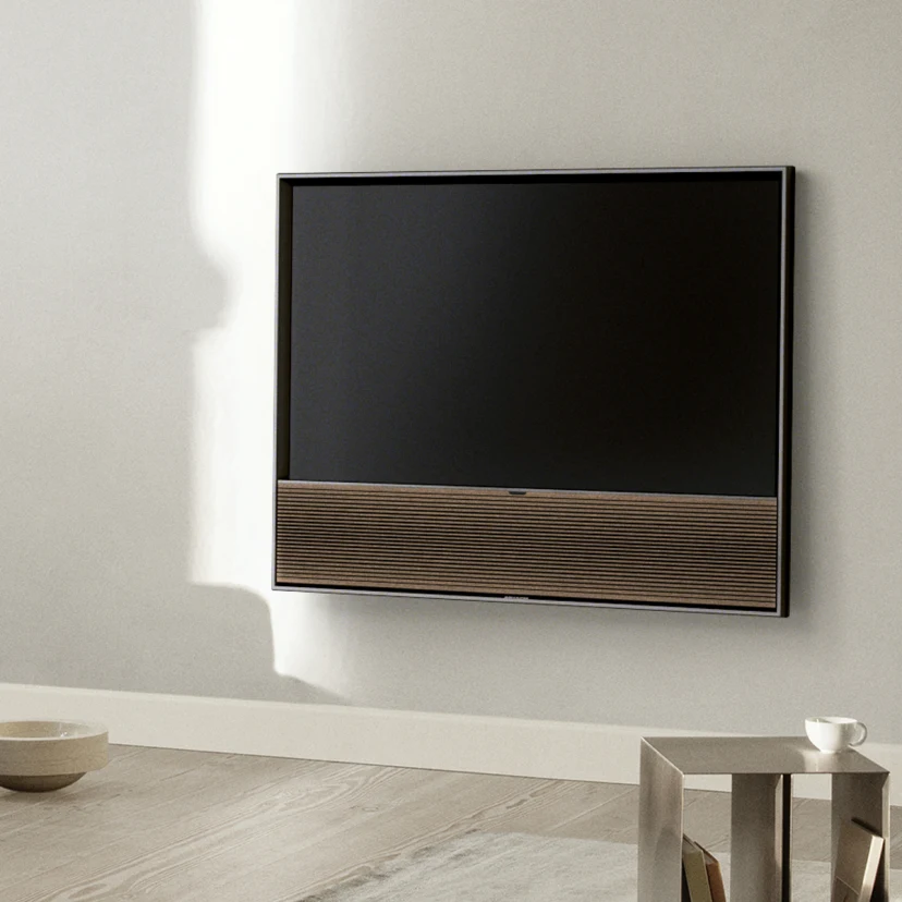 Beovision Contour TV in the Black Anthracite - Smoked Oak variant mounted on a wall in the livingroom
