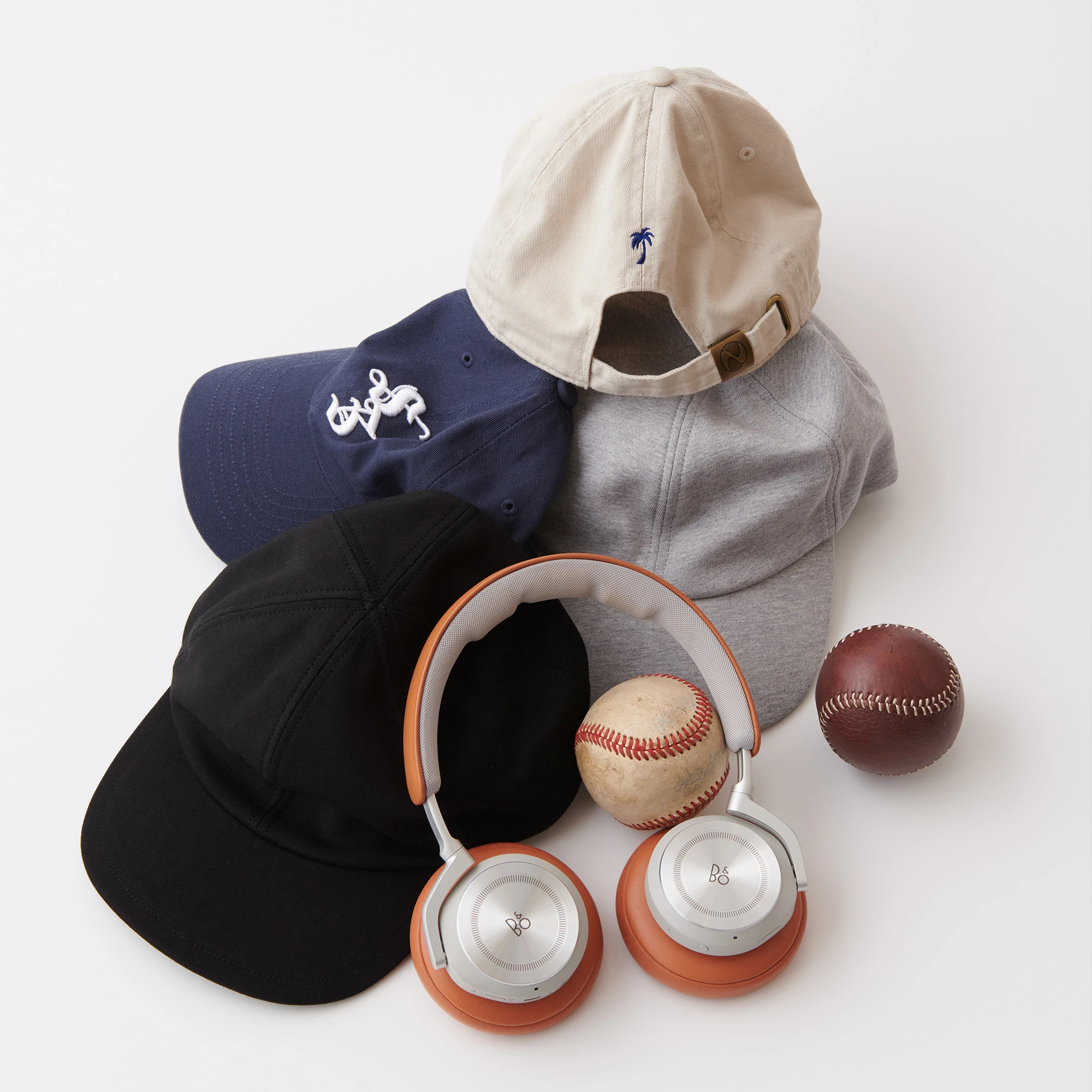 Beoplay HX Baseball with baseballs and baseball caps