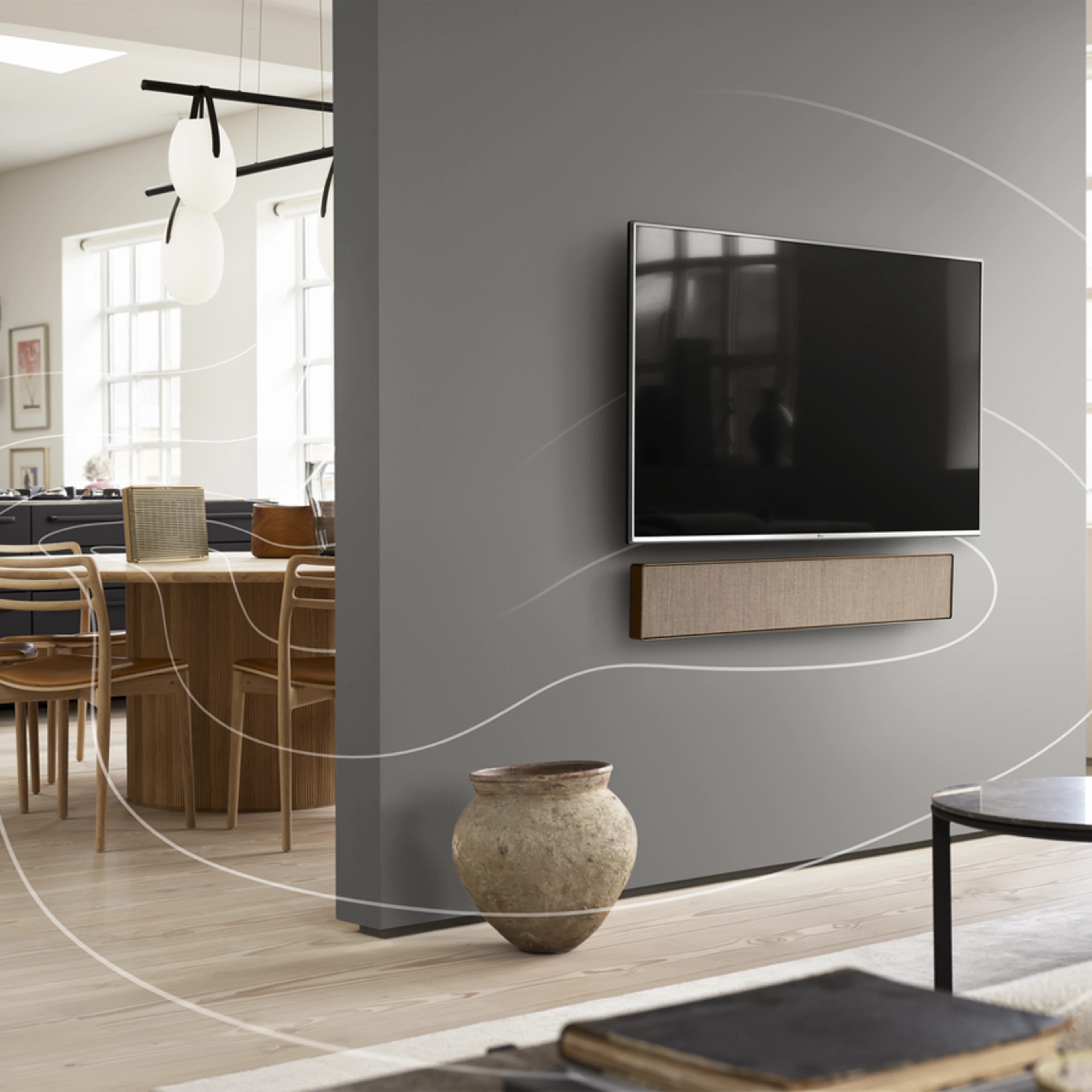 Beosound Level, Beosound Stage and Beosound Balance playing together in a connected speaker setup through out a living room and kitchen