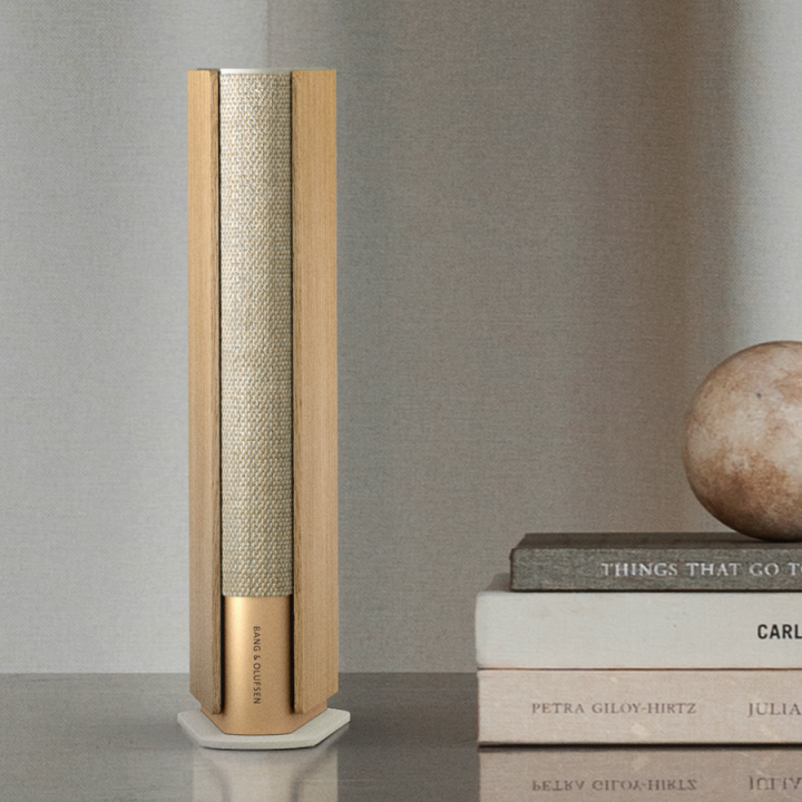 Beosound Emerge Gold Tone - Light Oak slim speaker on a bookshelf