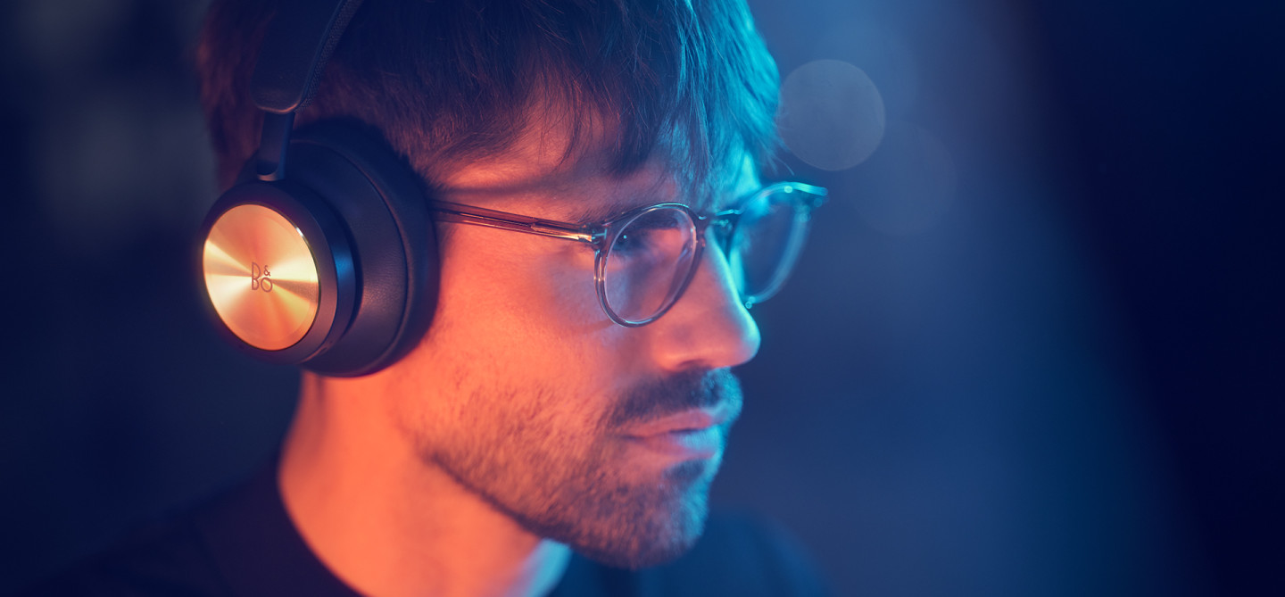 Man wearing Beoplay Portal while gaming