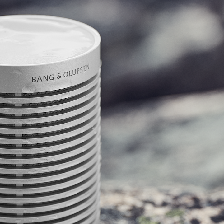 Beoplay Explore Grey Mist speaker covered with water drops