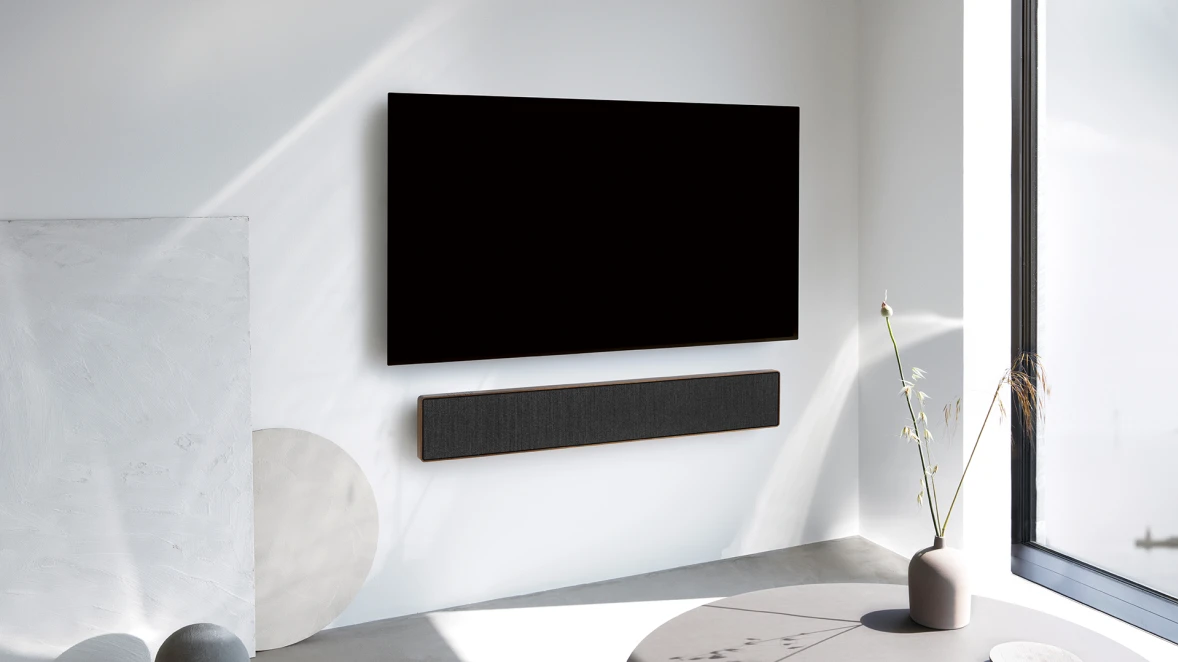 Beosound Stage soundbar speaker and a TV mounted on a wall