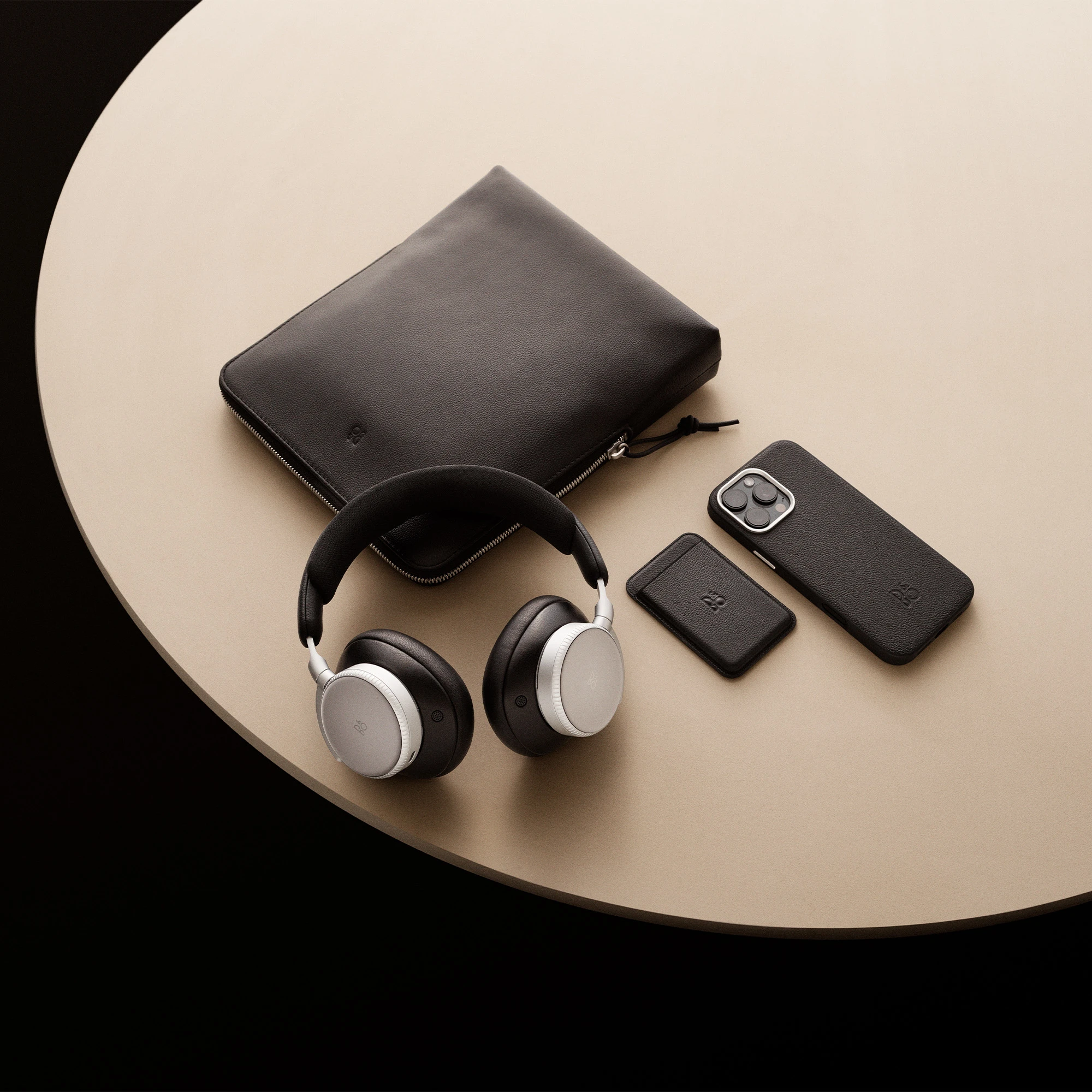 Image of iPhone 16 Pro case, magsafe card holder and H100 laying on a table