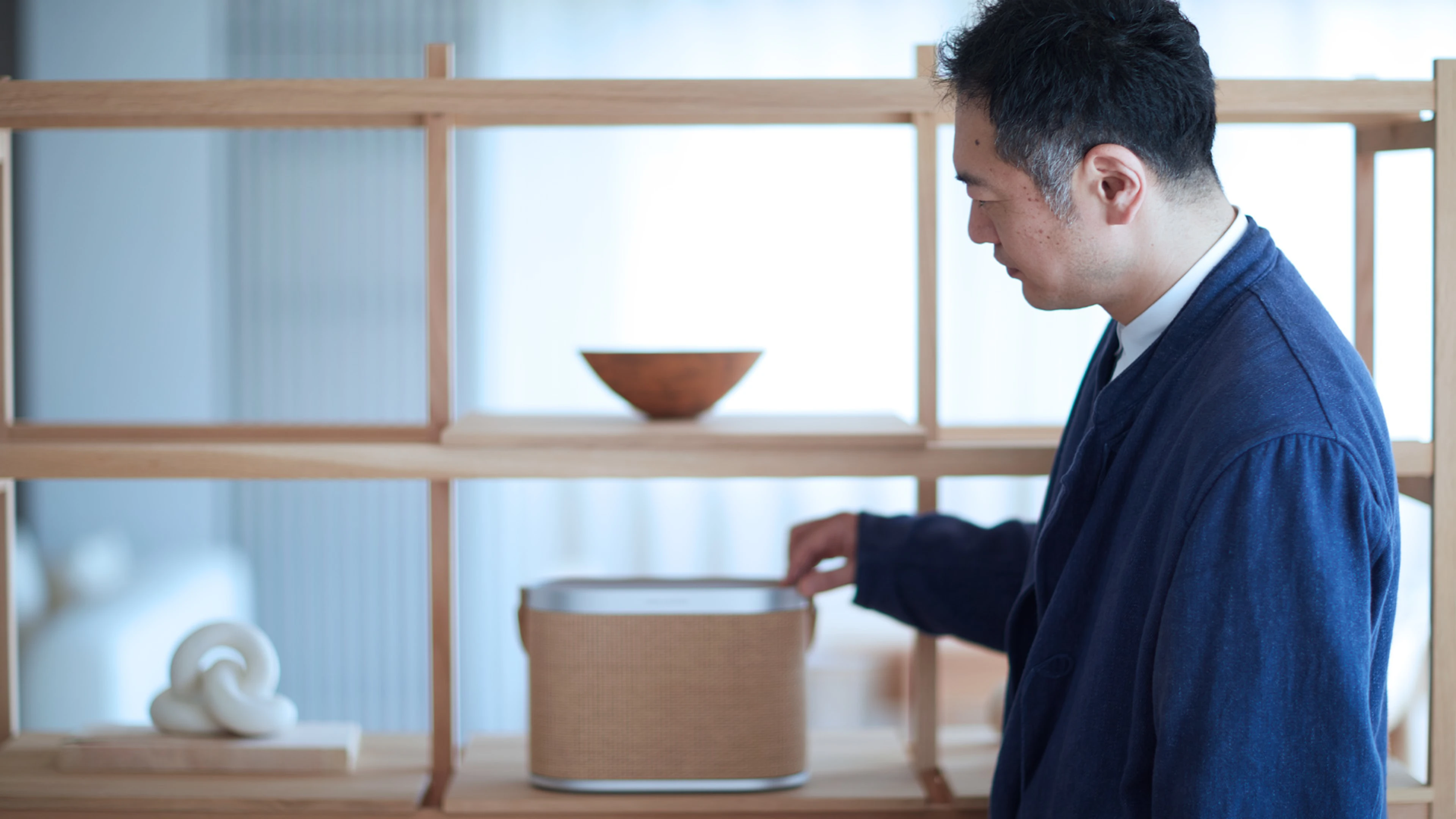 Image of man standing with Beosound A5
