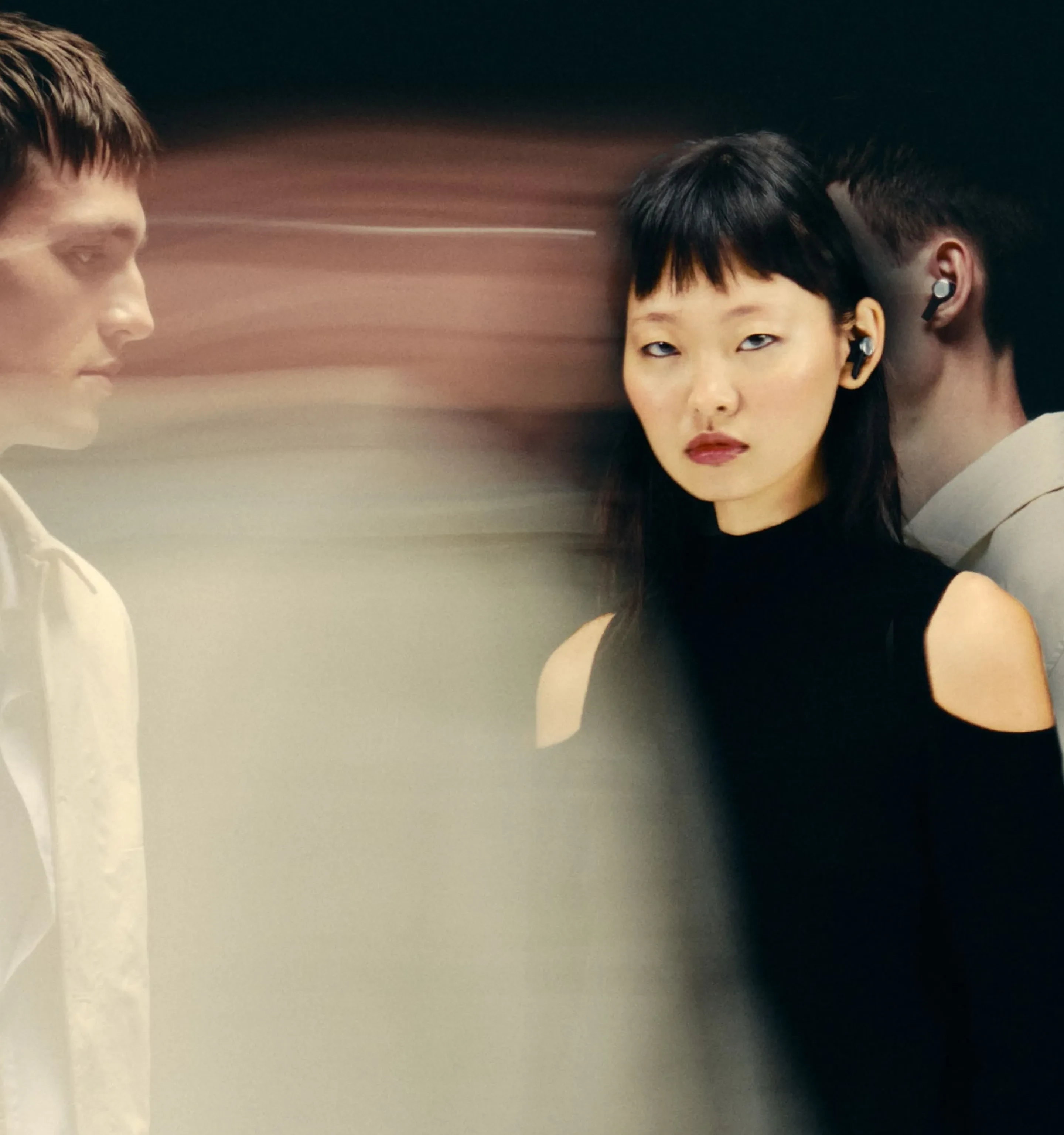 A woman wearing Beosound Eleven