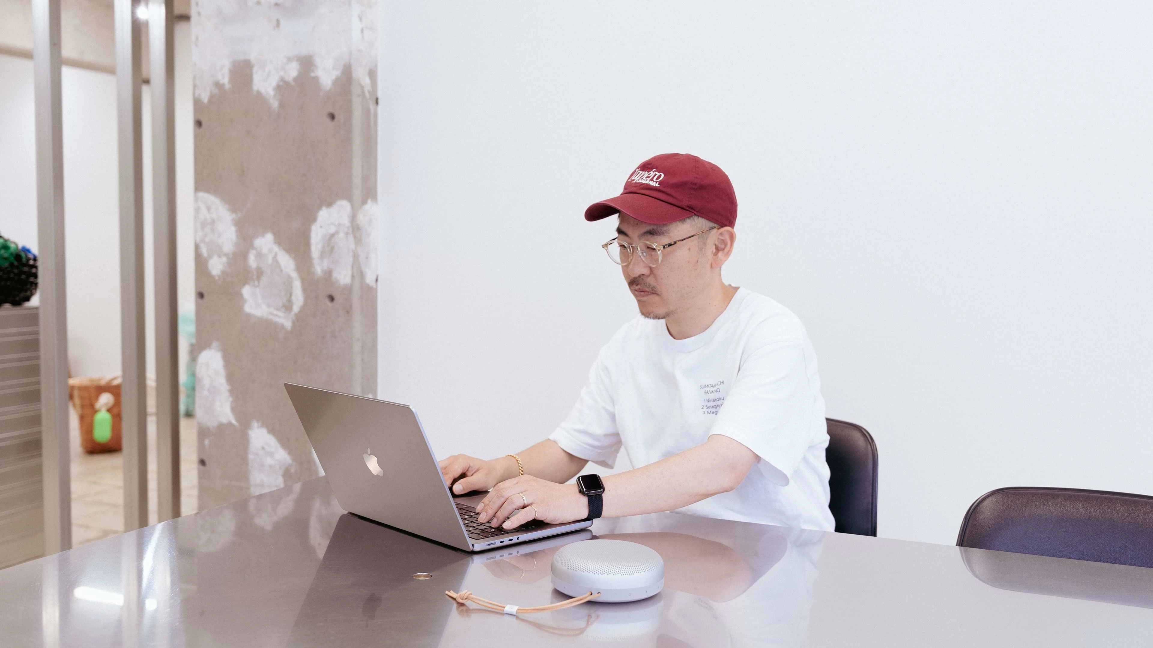 Person sitting at a computer with a Beosound A1