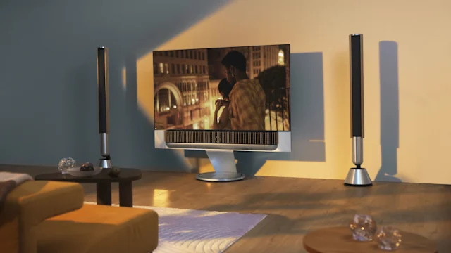 A pair of Beolab 28 speakers next to a Beovision Theatre television in a living room