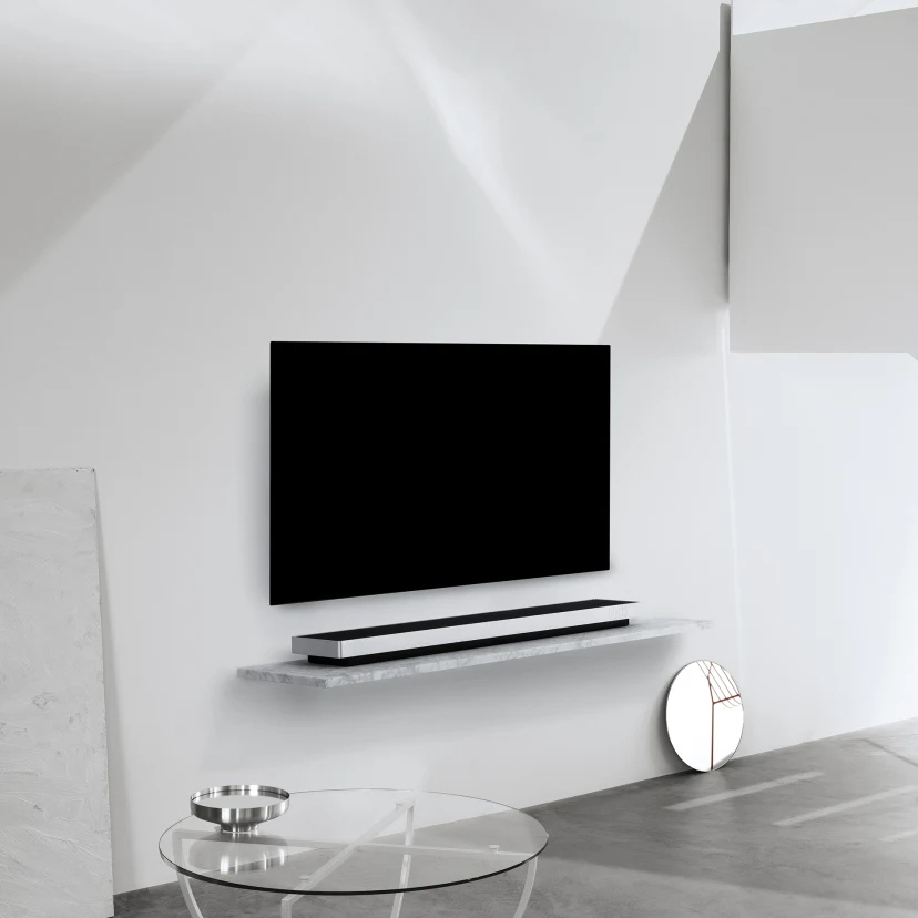 Soundbar on a surface and a TV mounted on the wall