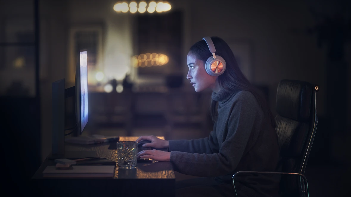 Woman playing video games with Xbox and Beoplay Portal