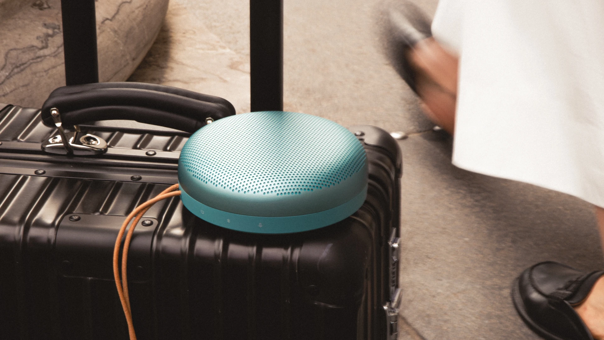 Beosound A1 3rd gen Eucalyptus Green on a black luggage