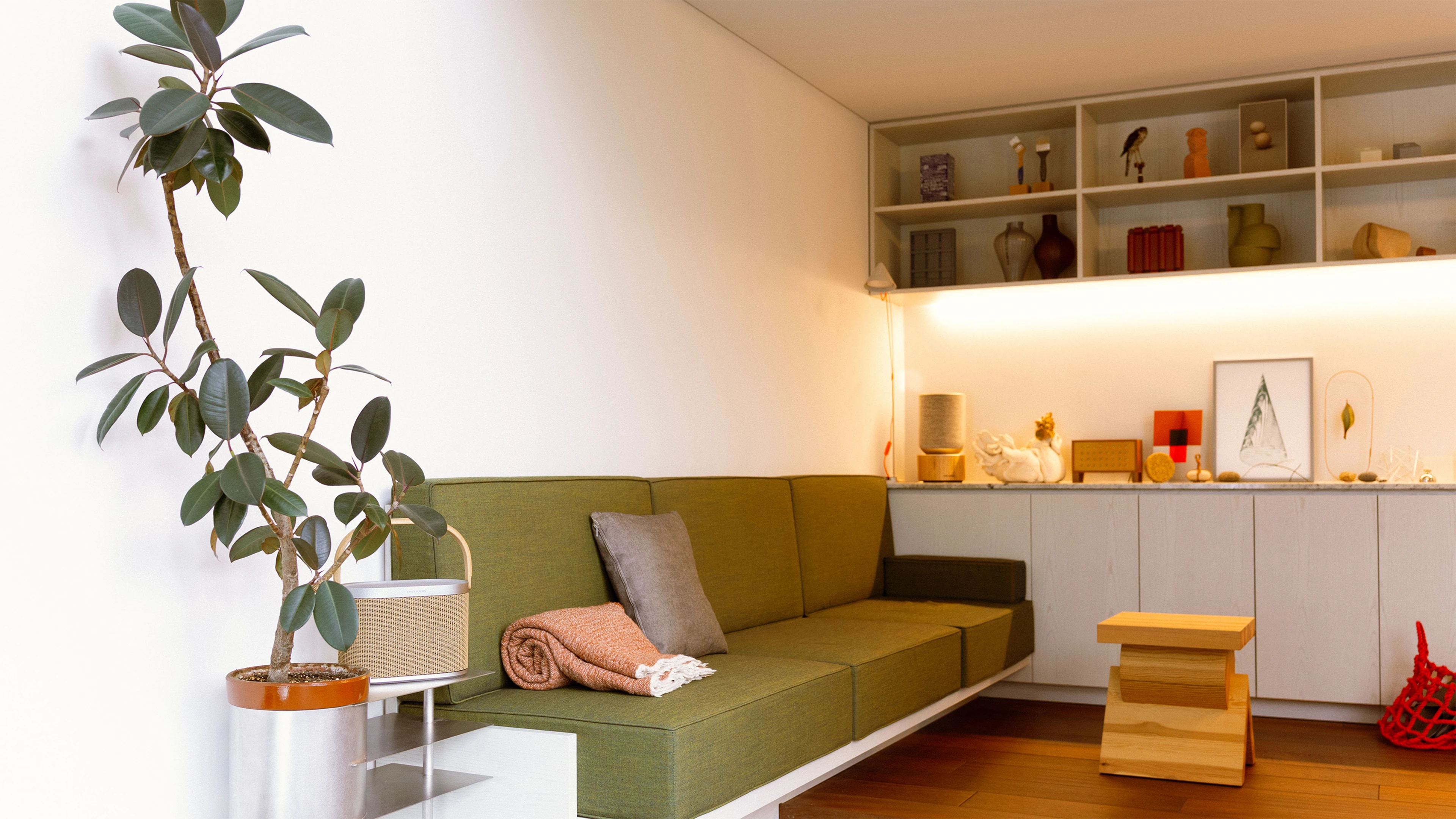 Living room with green couch and Beosound products