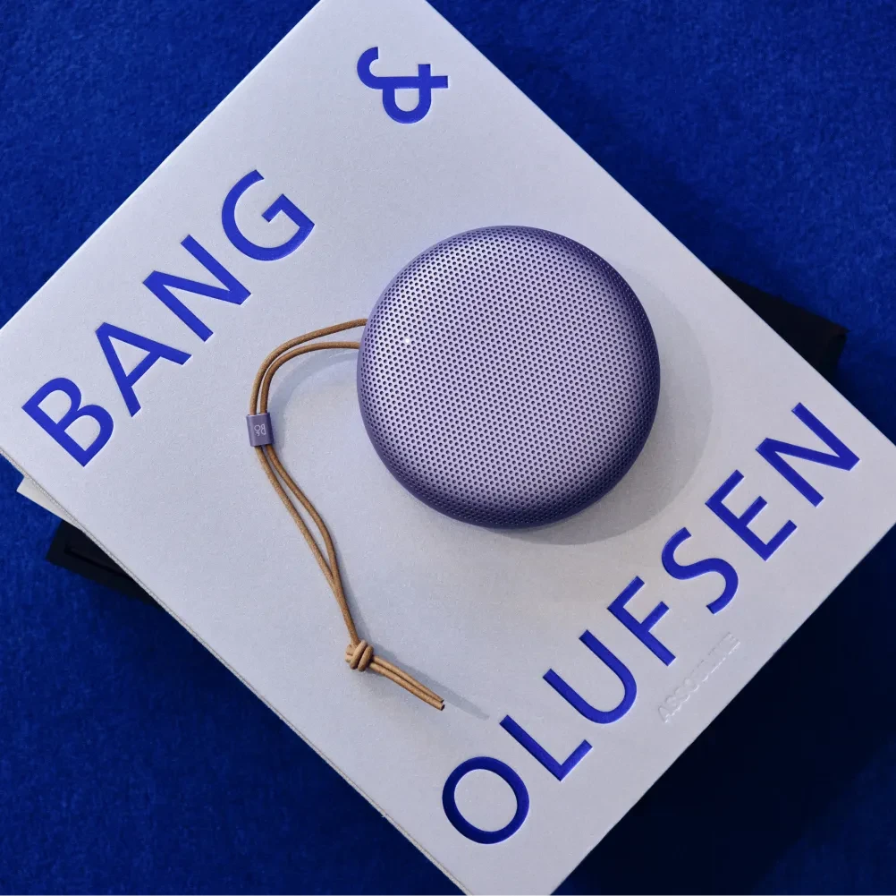 Beosound A1 3rd Gen Lavender Purple on top of Bang & Olufsen coffee table book